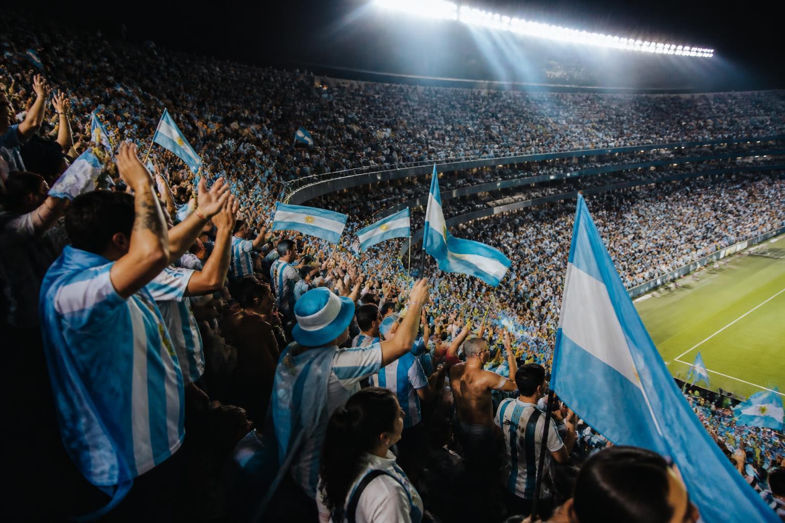 Interior del Arrowhead Stadium de Kansas City lleno de hinchas argentinos festejando bajo las luces